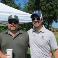Two men posing and smiling